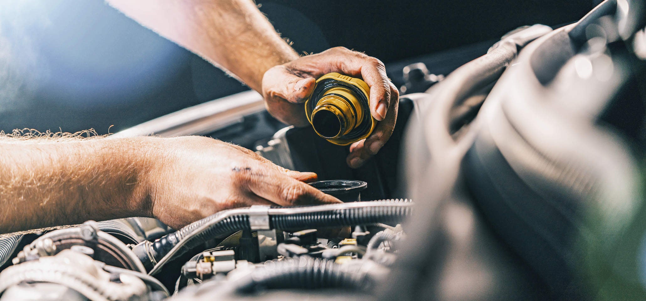 image of of a man closing the engine cap