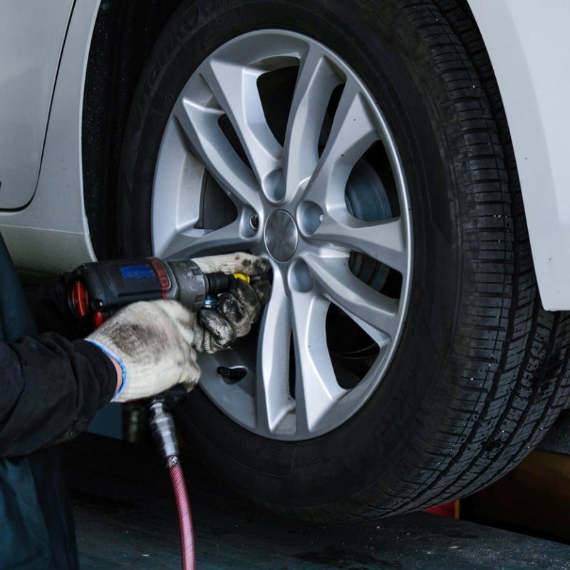 image of a man servicing a tire