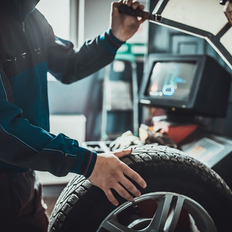 image of a man holding a tire