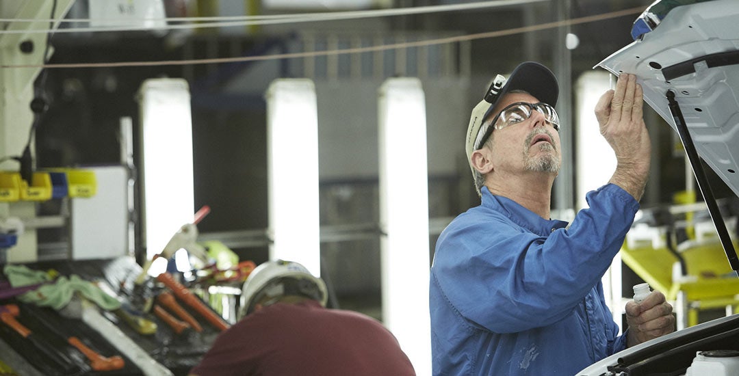 image of a man inspecting a vehicle